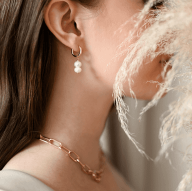 Woman wearing gold necklace and earrings